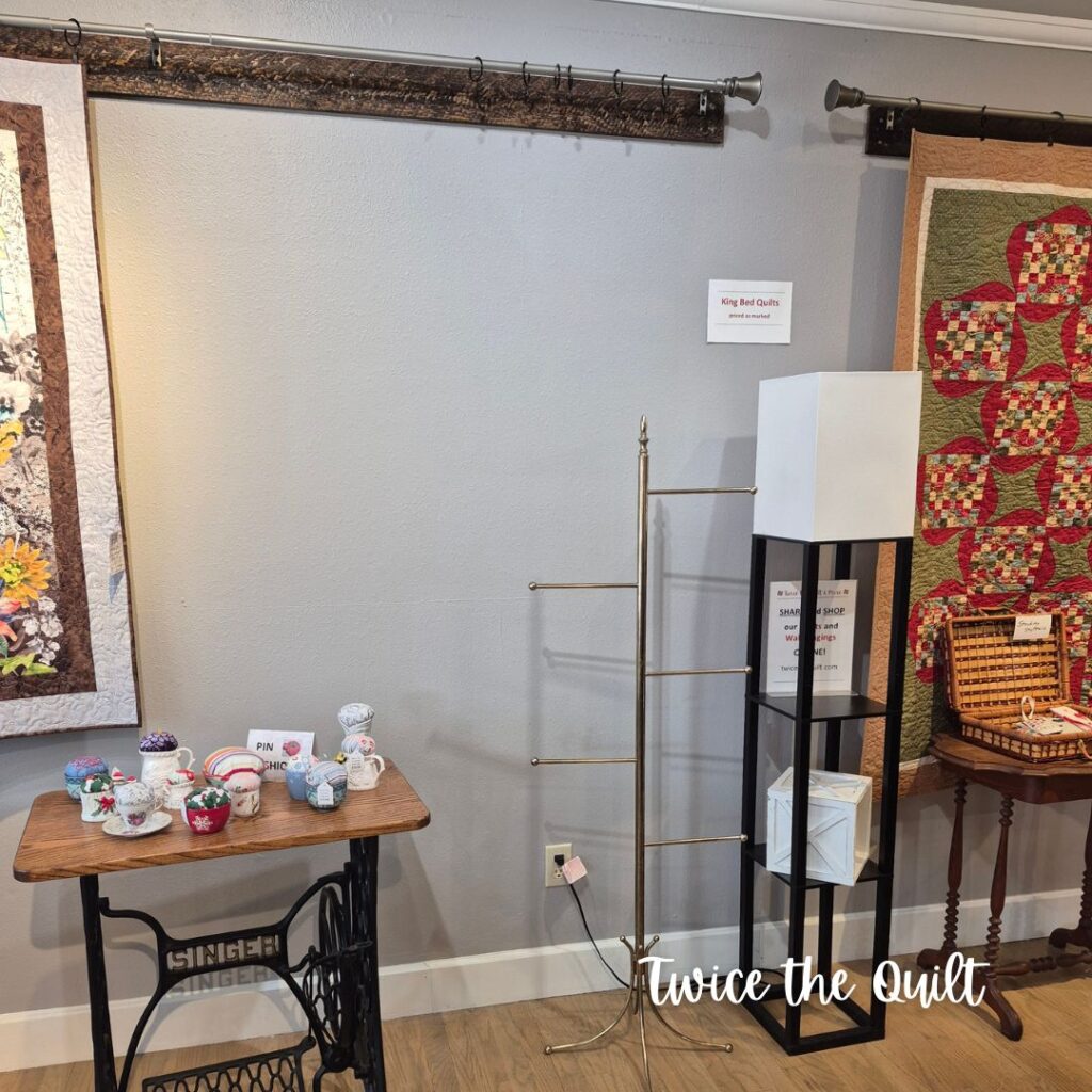 a blank wall waiting for a quilt for sale to be hung for display